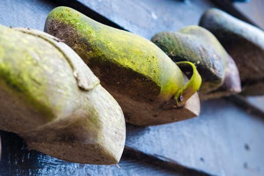 Zaanse Schans, Netherlands - January 10, 2017: Traditional handmade Dutch wooden shoes in Zaanse Schans village near Amsterdam, Netherlands. Klompen are whole feet clogs made of willow or poplar.