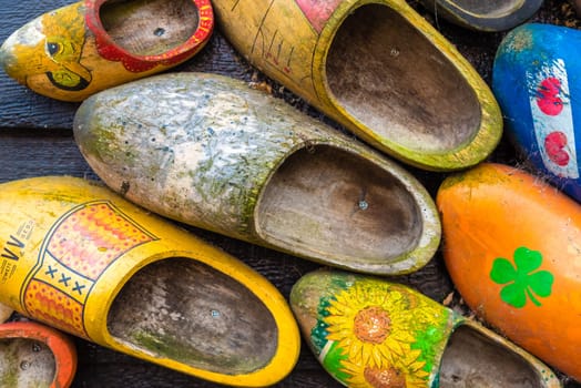 Zaanse Schans, Netherlands - January 10, 2017: Traditional handmade Dutch wooden shoes in Zaanse Schans village near Amsterdam, Netherlands. Klompen are whole feet clogs made of willow or poplar.