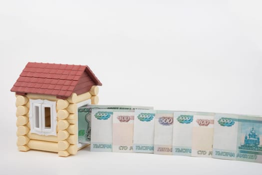 Before the doors open toy house lined up Russian rubles banknotes of different denomination
