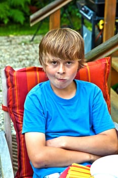 boy eating outside at a table on the patio