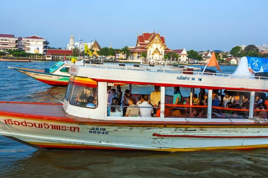 Bangkok, Thailand - January 4, 2010:  people in the boat at the river Mae Nam Chao Phraya in Bangkok, Thailand. Boat ferry is a regular public service on the river.