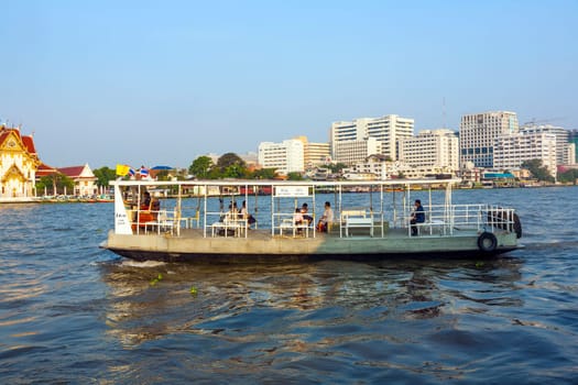 Bangkok, January 4, 2010: people in the boat at the river Mae Nam Chao Phraya in Bangkok, Thailand. Boat ferry is a regular public service on the river.  More than 15 boat lines operate on the river including commuter lines.