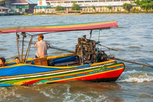 Bangkok, Thailand - January 4, 2010: people in the boat at the river Mae Nam Chao Phraya  in Bangkok, Thailand. Boat ferry is a regular public service on the river.