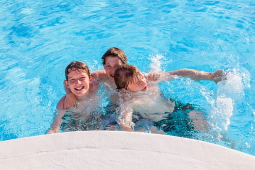 cute boys have fun in the pool