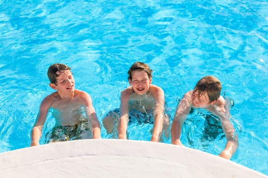 cute boys have fun in the pool
