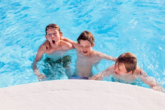 cute boys have fun in the pool