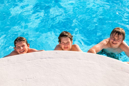 cute boys have fun in the pool