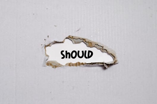 The word should appearing behind torn paper