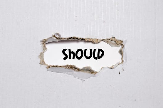 The word should appearing behind torn paper