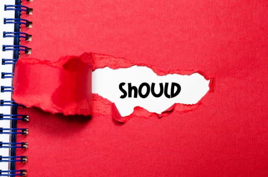 The word should appearing behind torn paper