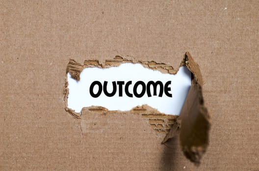 The word outcome appearing behind torn paper