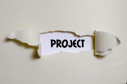 The word project appearing behind torn paper