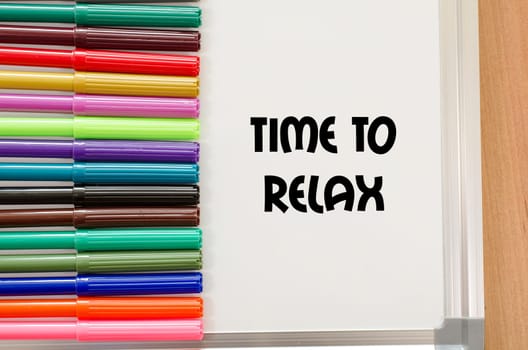 Felt-tip pen and whiteboard on a wooden background and text concept