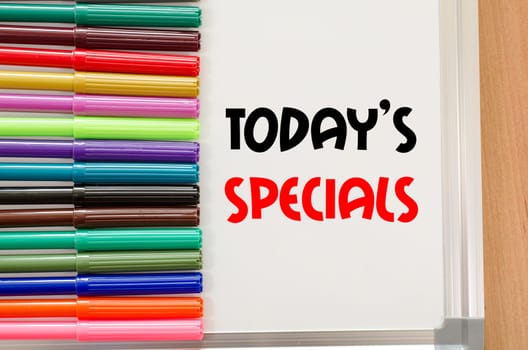 Felt-tip pen and whiteboard on a wooden background and text concept