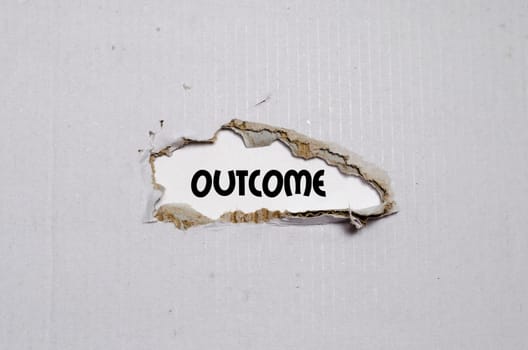 The word outcome appearing behind torn paper
