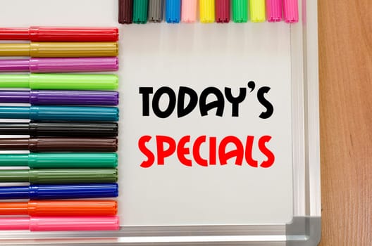 Felt-tip pen and whiteboard on a wooden background and text concept
