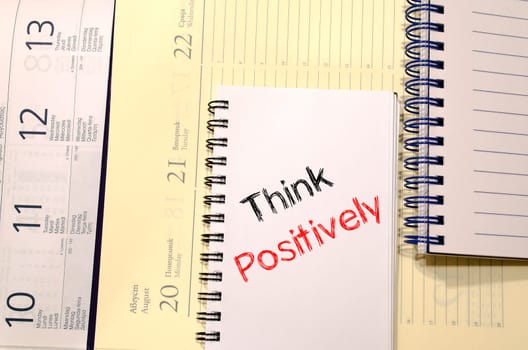 Think positively text concept write on notebook