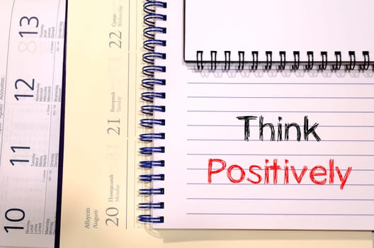 Think positively text concept write on notebook