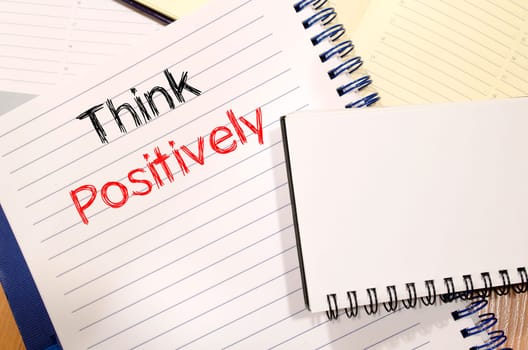 Think positively text concept write on notebook