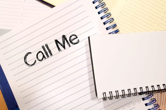 Call me text concept write on notebook