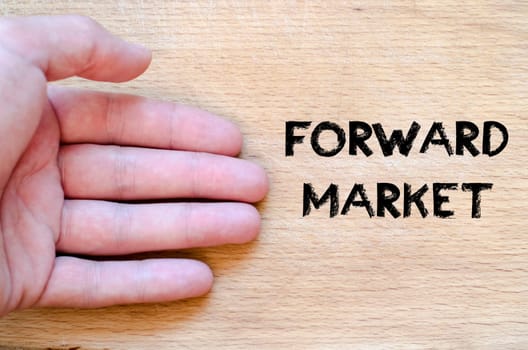 Human hand over wooden background and forward market text concept