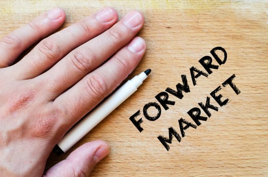 Human hand over wooden background and forward market text concept