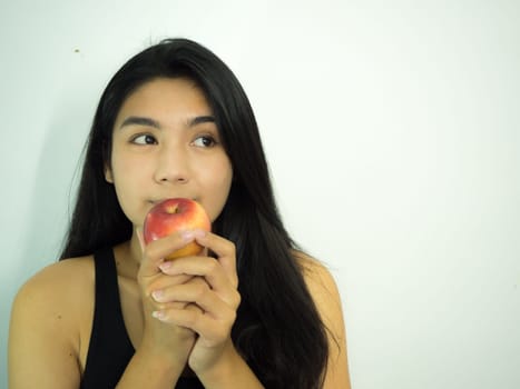 Asian woman holding red apple on white background