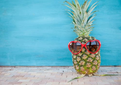 Pineapple with heart sunglasses,concept for travel and holidays