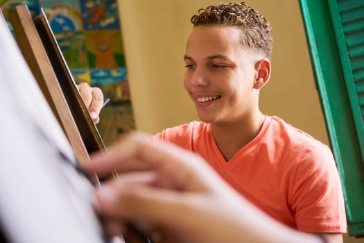 School of art, college of arts, education for group of students. Happy young man smiling, learning to paint for job, profession, hobby