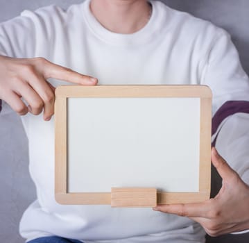 Woman holding a blank whiteboard, stock photo