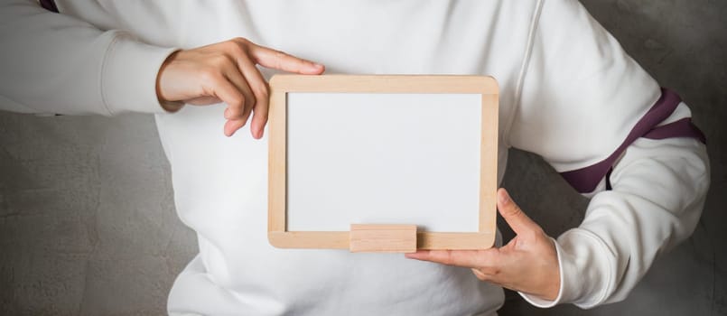 Woman holding a blank whiteboard, stock photo