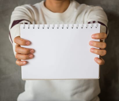Woman holding a blank notepaper, stock photo