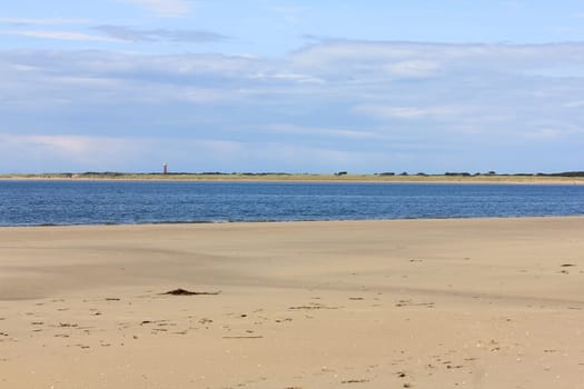 Lonely sandy beach,with blue sky and few clouds.