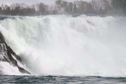 Waterfall with white,foaming spray