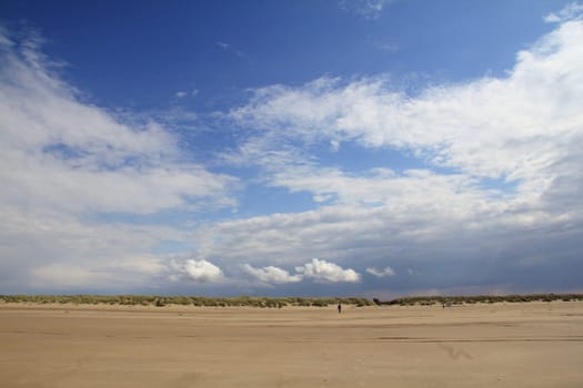 Lonely sandy beach,with blue sky and few clouds.