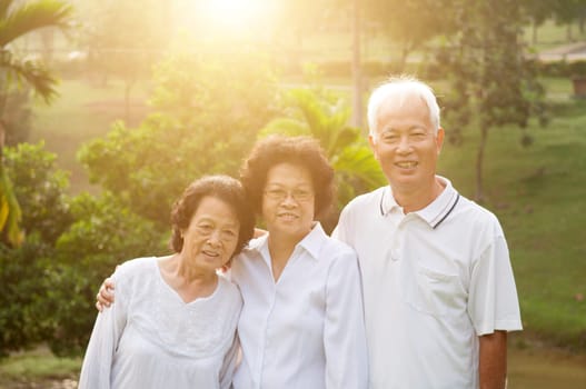 Group of healthy Asian seniors having activities at outdoor nature park, in morning beautiful sunlight at background.
