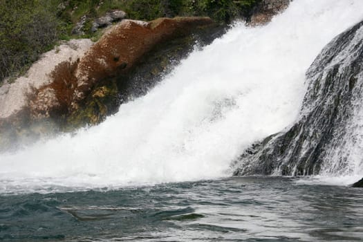 Waterfall with white,foaming spray