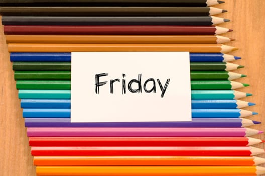 Blank white paper and colored pencils on wooden background