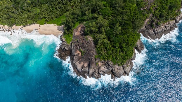 Panoramic view showcasing lush green coastline with turquoise waters stretching into the horizon. Seychelles, Mahe.