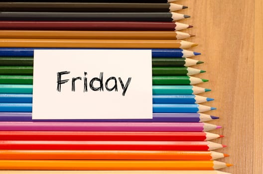 Blank white paper and colored pencils on wooden background