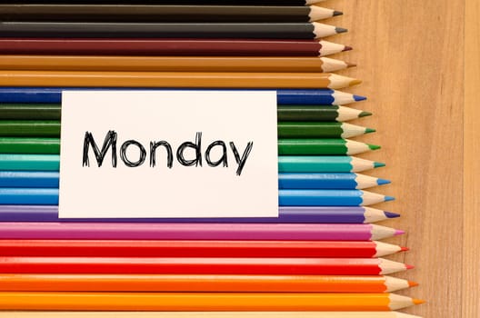 Blank white paper and colored pencils on wooden background