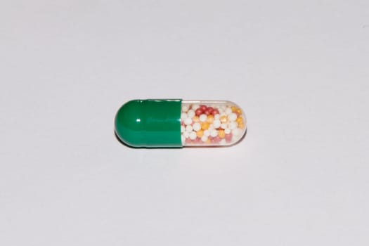 Tabs Vitamins, omega 3, Medications tablets and capsules in a beaker. Medications tablets, suppository bottles, capsules and thermometer on wooden table