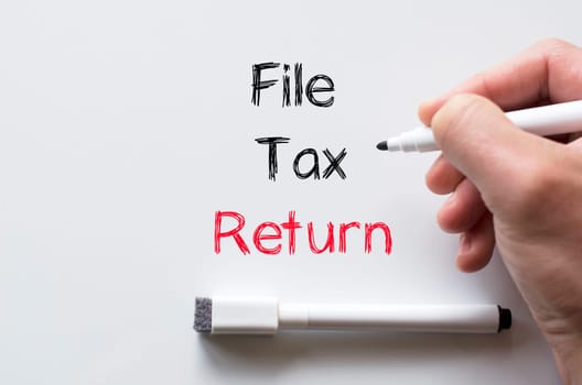 Human hand writing file tax return on whiteboard
