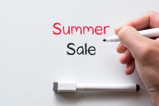 Human hand writing summer sale on whiteboard