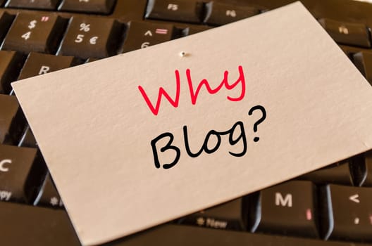 Why blog text concept on white memo and dark keyboard background