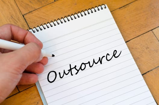 Outsource text concept write on notebook