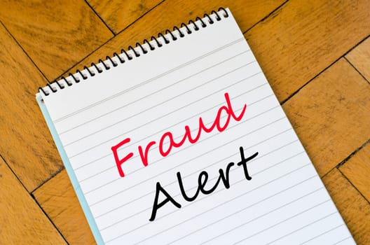 Fraud alert text concept write on notebook