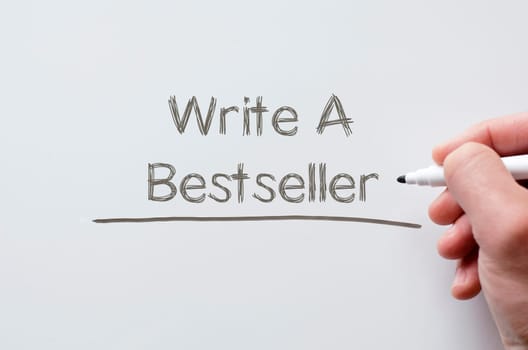 Human hand writing write a bestseller on whiteboard