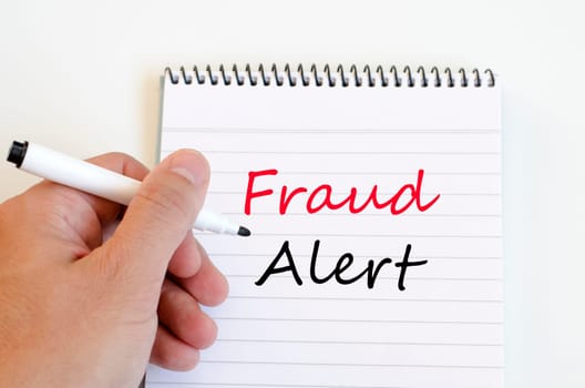 Fraud alert text concept write on notebook