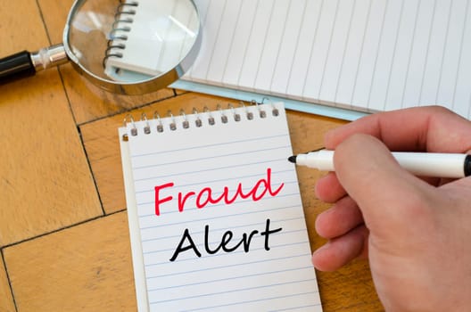 Fraud alert text concept write on notebook